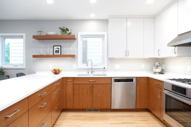 A kitchen with natural wood cabinets combined with white cabinets. 3587-1 After