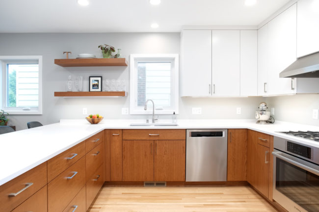 A kitchen with natural wood cabinets combined with white cabinets. 3587-1 After
